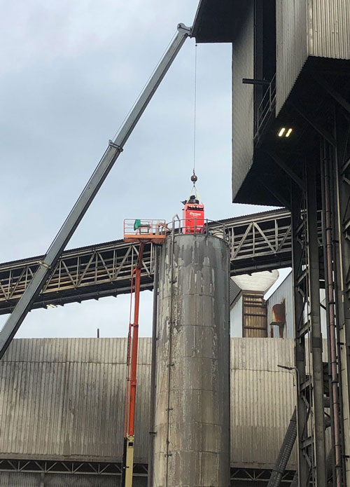 SMAC being installed on top of a steel mill storage silo as a bin vent