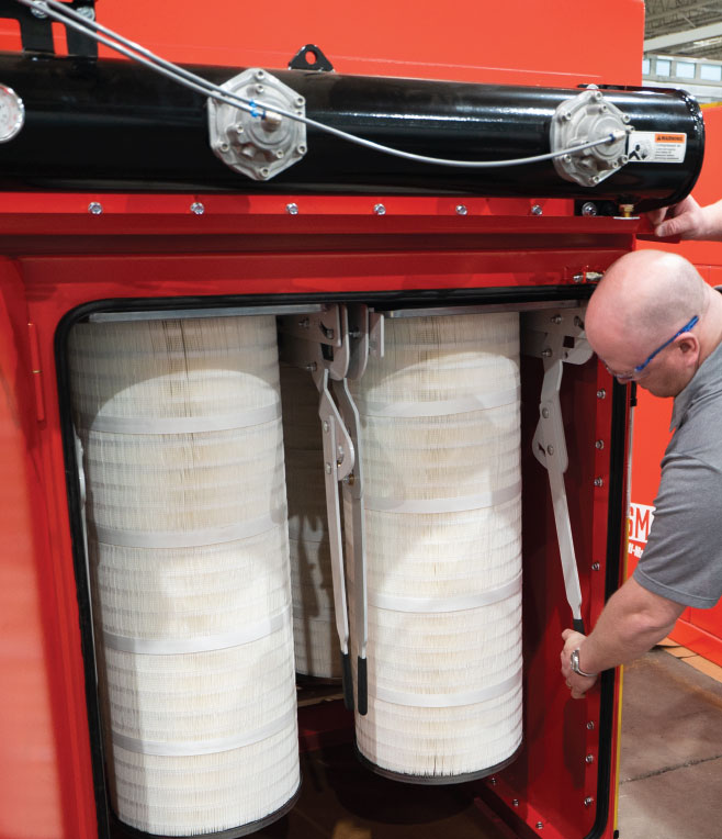 Man replacing filters in the Self-Maintaining Air Cleaner