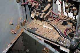 opened electrical cabinet reveals heavy dust accumulation inside